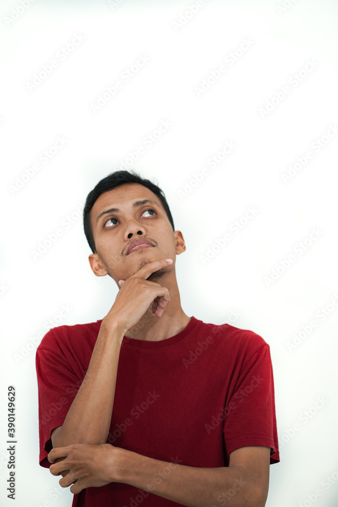 a young man from Southeast Asia wearing a red shirt is thinking expression on a white background a young man from Southeast Asia wearing a red shirt is thinking expression on a white background