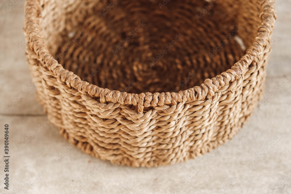 Fototapeta premium Empty round wicker basket on a old wooden background. Top view. Copy, empty space for text