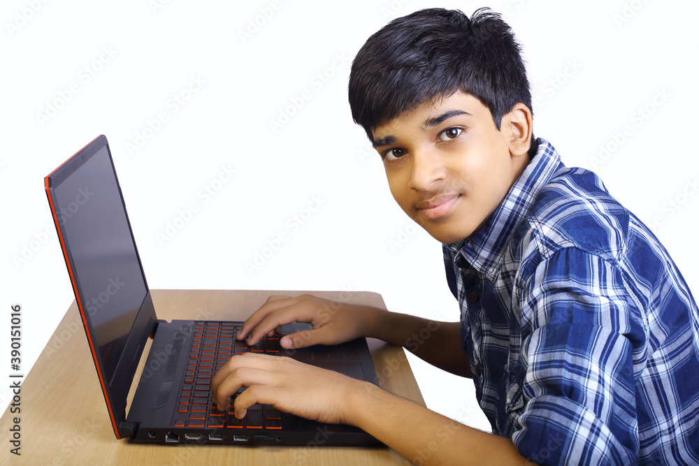 Portrait of Indian boy using laptop while attending the online classes Portrait of Indian boy using laptop while attending the online classes