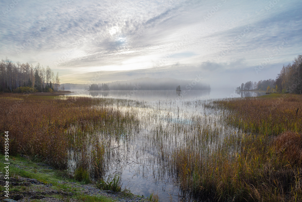 Autumn, foggy morning, over the lake, in the distance you can see a small island. Finland, Scandinavian nature. Autumn, foggy morning, over the lake, in the distance you can see a small island. Finland, Scandinavian nature.