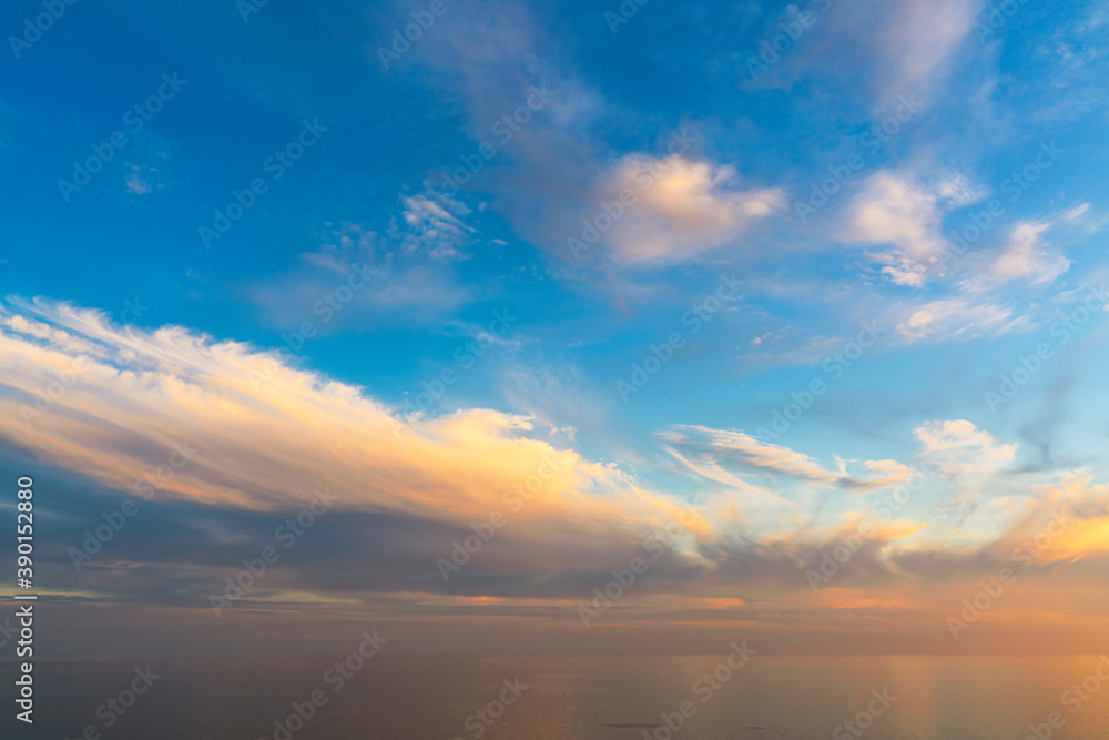 Beautiful sunset sky with clouds, the horizon merges with the sea, backgrounds . High quality photo.