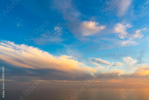 Beautiful sunset sky with clouds, the horizon merges with the sea, backgrounds . High quality photo.