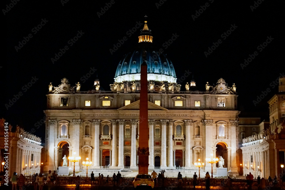 St peters basilica catholic church in Italy Rome during night time with lights on. Architecture and building concept.