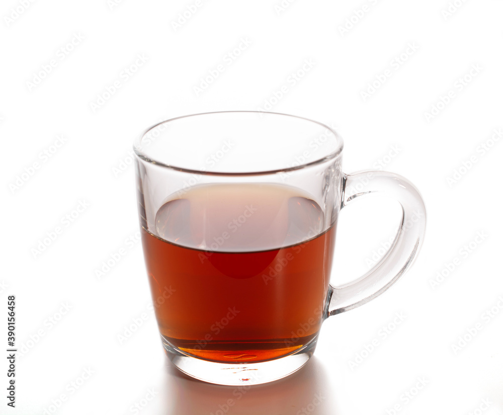 transparent mug with black tea on a white background. transparent mug with black tea on a white background.