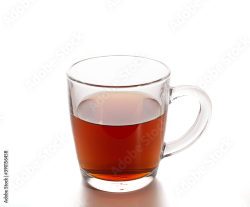 transparent mug with black tea on a white background.