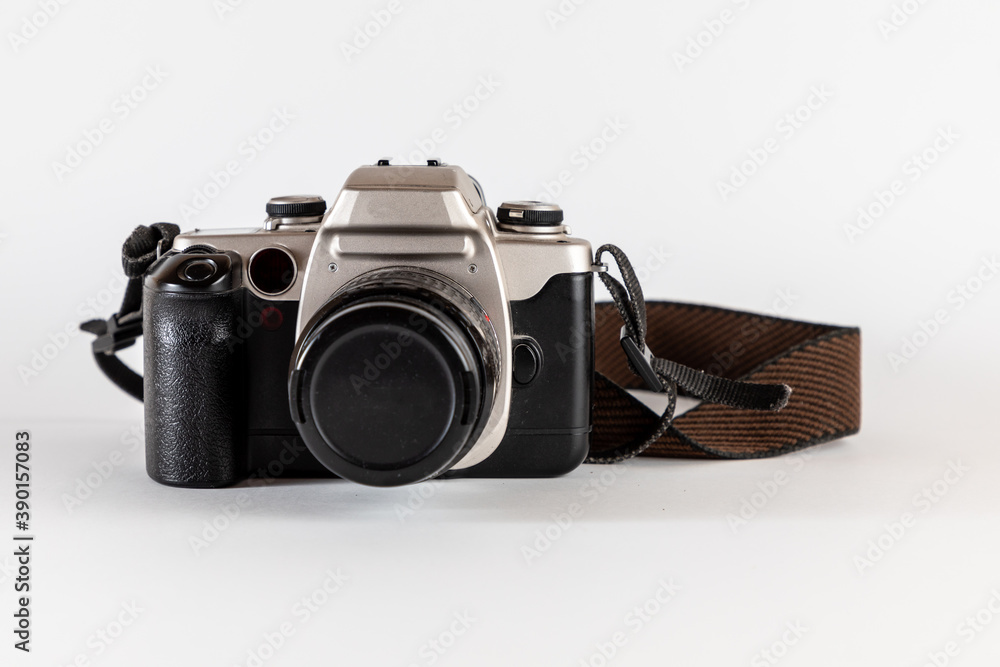 Old photo camera, analog reflex camera or roll camera with old brown strap. Professional camera.