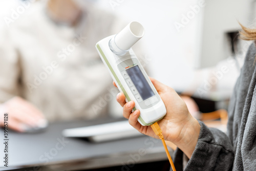 Patient holding spirometer photo