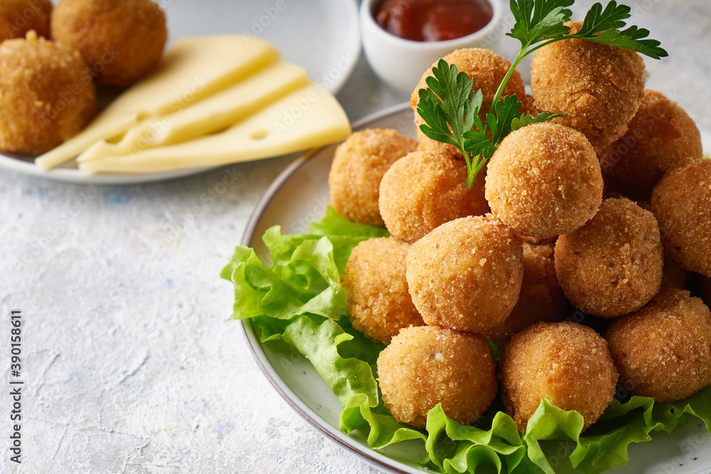 cheese balls, appetizer with herbs and sauces in a plate on a gray table cheese balls, appetizer with herbs and sauces in a plate on a gray table