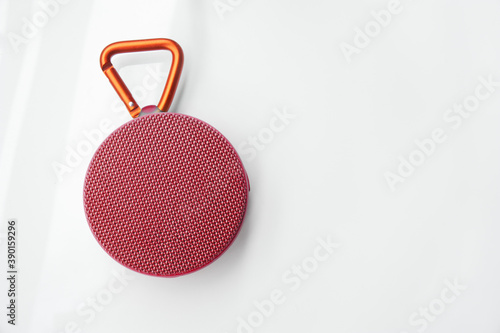 Portable red bluetooth speaker, isolated on white.