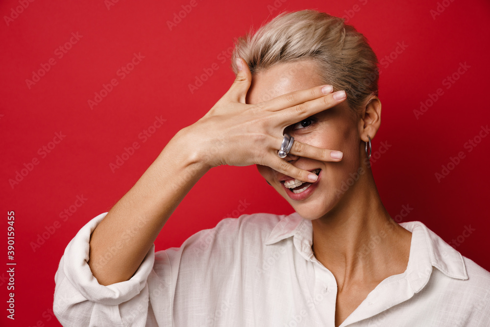 Happy beautiful blonde girl smiling and covering her face Happy beautiful blonde girl smiling and covering her face