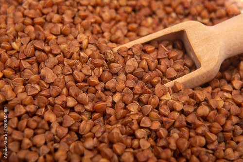 Dry buckwheat close-up with a wooden spoon