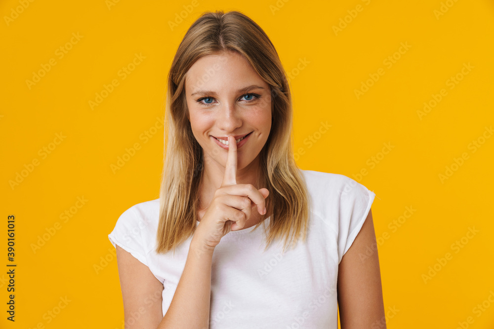 Happy beautiful girl smiling and showing silence gesture Happy beautiful girl smiling and showing silence gesture