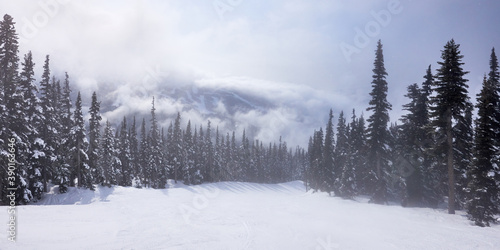 Misty panoramic view of the ski piste at Whistler ski resort in Canada in the winter season.