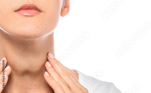 Woman palpation her neck, examine thyroid gland. Enlarged thyroid gland, close-up on white background