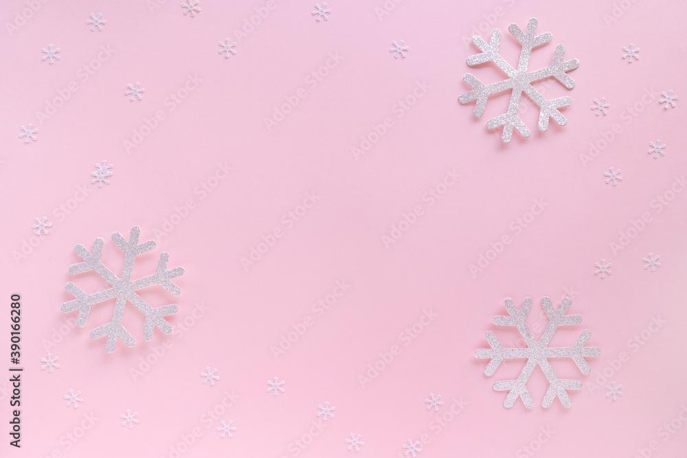 Christmas composition. Christmas frame made of snowflakes on pastel pink background. Christmas or New Year 2021 minimal concept. Flat lay, top view, copy space Christmas composition. Christmas frame made of snowflakes on pastel pink background. Christmas or New Year 2021 minimal concept. Flat lay, top view, copy space