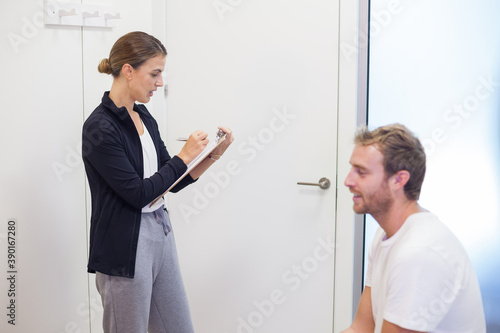 female physiotherapist consults young patient