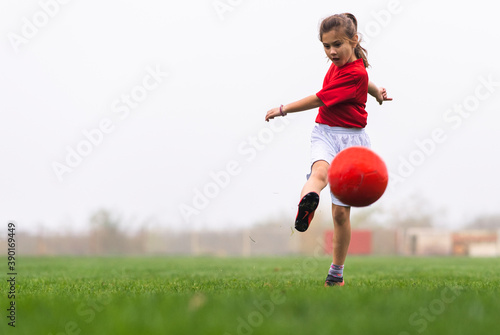 Little girl kicks soccer ball © Dusan Kostic