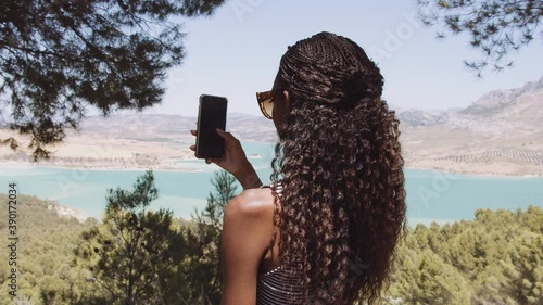 Black Woman Using Smartphone In Spain