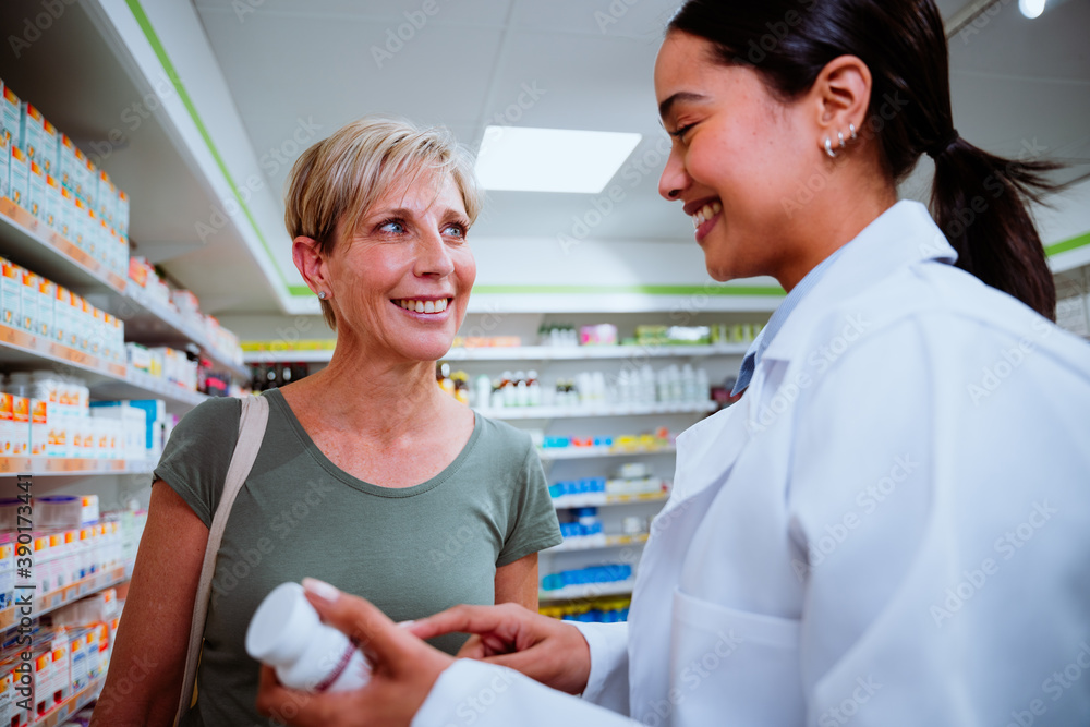Mixed race female assisting mother finding medication in drugstore pharmacy Mixed race female assisting mother finding medication in drugstore pharmacy