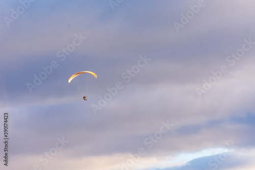 Paragliding against snow-capped Andes mountains during winter season in Esquel, Patagonia, Argentina