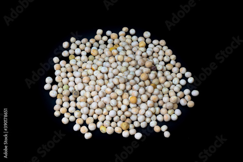 Scattered  dry peas isolated on black background
