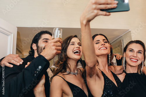 Socialites taking selfie at a party photo