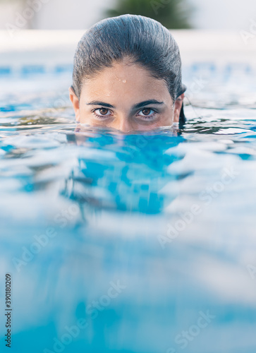 Vertical shot of a young lady in the water