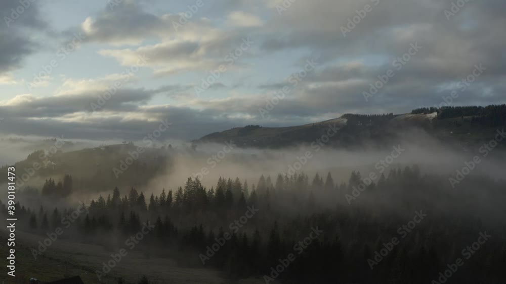 Clouds over mountain forest in the morning at sunrise in autumn in 4K Clouds over mountain forest in the morning at sunrise in autumn in 4K