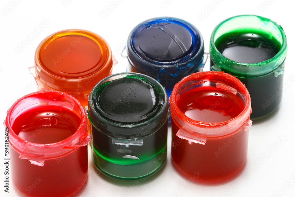 Pots of colourful acrylic glass paints isolated on a white background Pots of colourful acrylic glass paints isolated on a white background