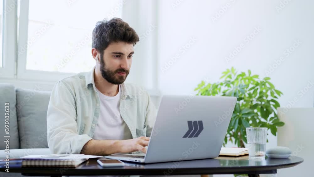 Male student learning at home using laptop Male student learning at home using laptop