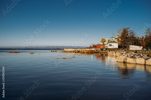 rocky coast of wild beach near life-boat station. Bank of gulf of finland on sunny october day. Calm sea concept