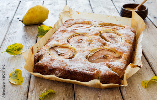 Homemade pears cake on natural wooden background