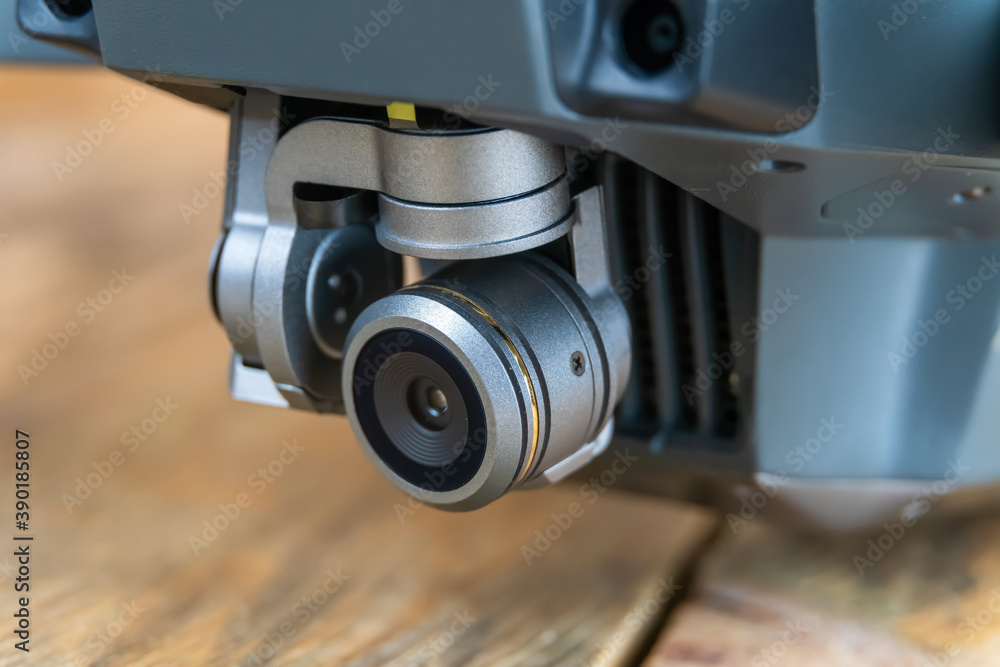 Camera of a gray quadrocopter close up standing on a table