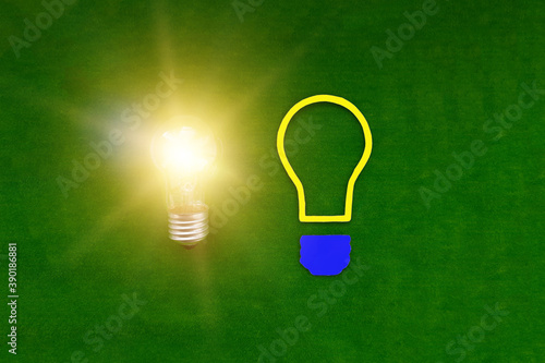 Two light bulbs on a green background. Ideas, creativity. Thinking.