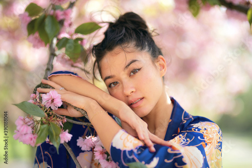 Portrait of woman leaning on branch