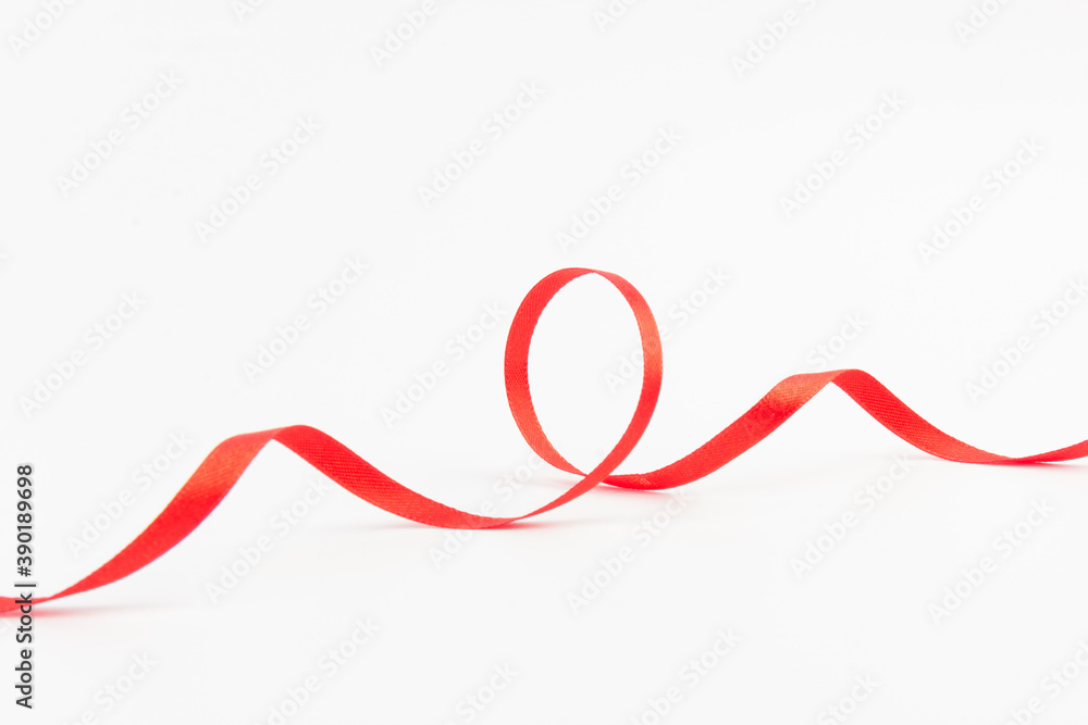 Top view of Red ribbon isolated shiny rolled on white background. Flat lay view. Top view of Red ribbon isolated shiny rolled on white background. Flat lay view.