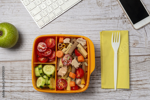 Lunch at workplace healthy pasta with tuna, tomatoes, in lunch box