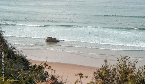 Surfer im Wasser an kantabrischem Strand photo