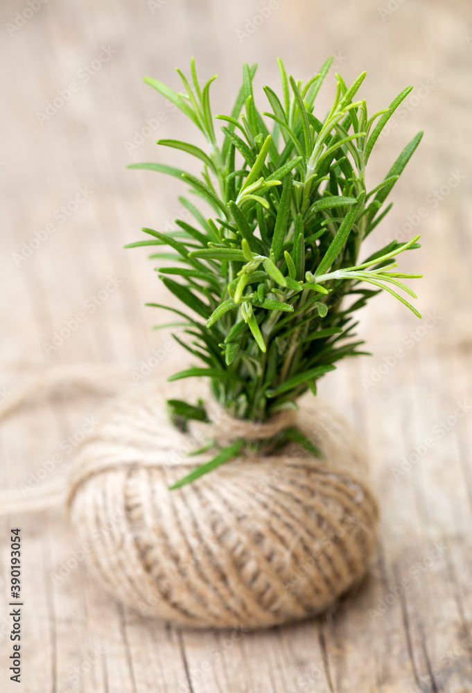 Fresh green herbal rosemary on wooden background Fresh green herbal rosemary on wooden background