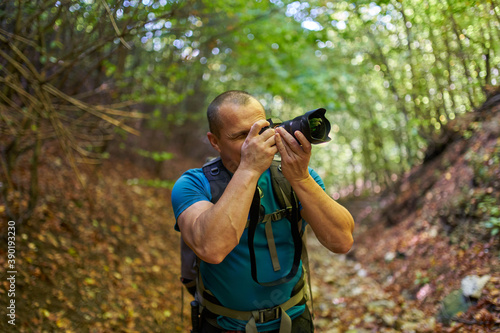 Nature photographer hiking into the forest