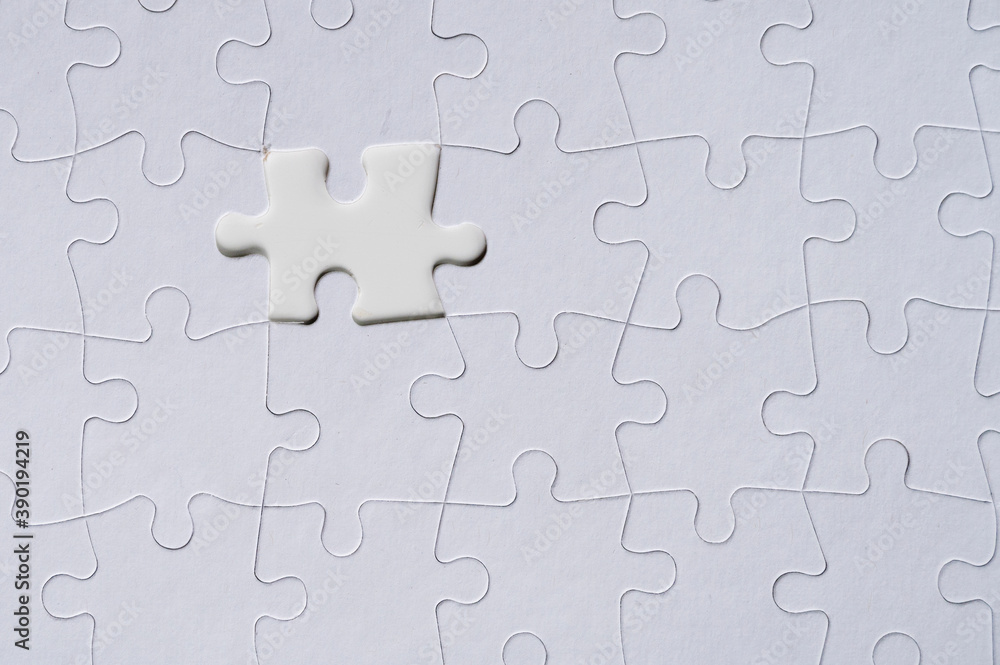 White jigsaw piece on jigsaw pattern White jigsaw piece on jigsaw pattern