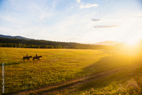 USA, Utah, Salem, Sisters (14-15) riding horses at sunset
