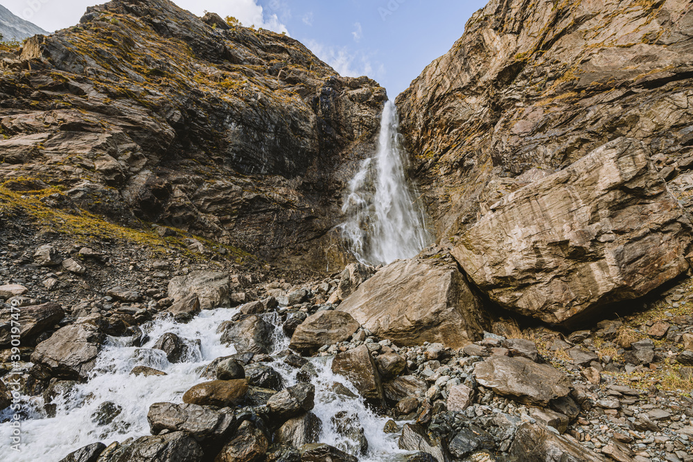 Waterfall in mountain. Hiking and ecotourism in Caucasus mountain.