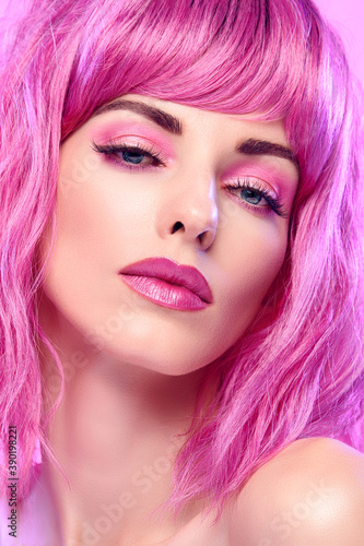 Beauty Fashion woman with Colorful Pink Dyed Hair. Girl with blue eyes  perfect Makeup and Hairstyle. Beautiful smiling model portrait  fashionable pink make up  hair. Skincare concept