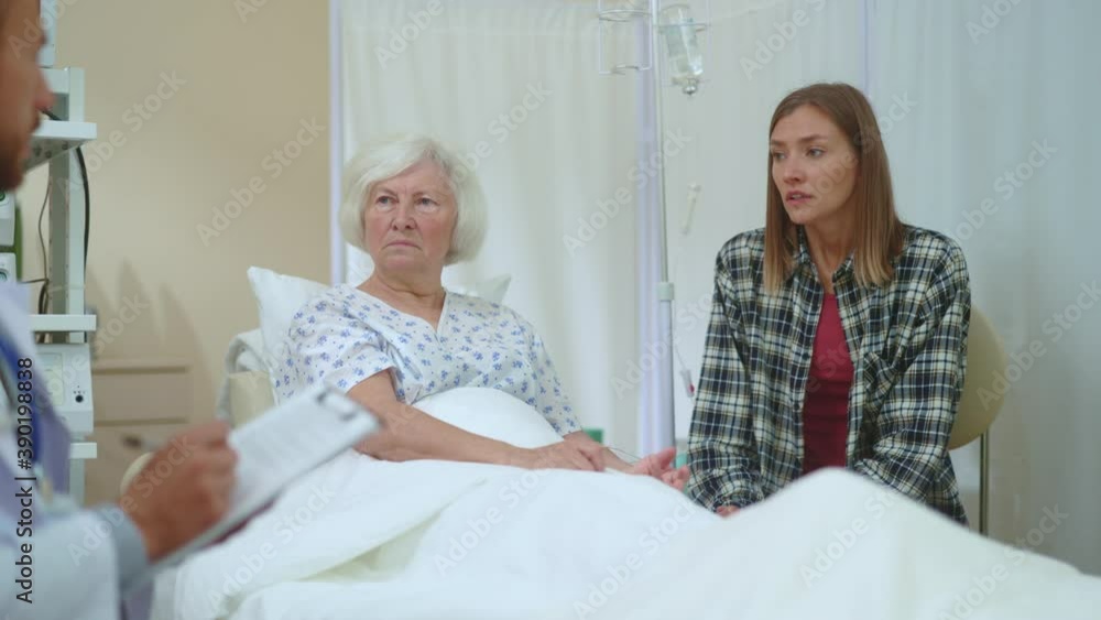 Caucasian family two women being told bad diagnosis frustrating feeling sad. Unhappy situation. Dreadful disease. Healthcare, family support. Hospital room. Doctor appointment. Caucasian family two women being told bad diagnosis frustrating feeling sad. Unhappy situation. Dreadful disease. Healthcare, family support. Hospital room. Doctor appointment.