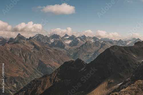 Panoramic view of mountain peaks. Summer in mountains. Hiking and ecotourism in mountain. 