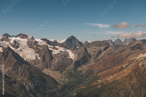 Panoramic view of mountain peaks. Summer in mountains. Hiking and ecotourism in mountain.  © Danil Nikonov