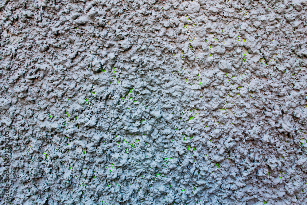An old dirty brick wall with peeling lilac, in some places pink paint An old dirty brick wall with peeling lilac, in some places pink paint