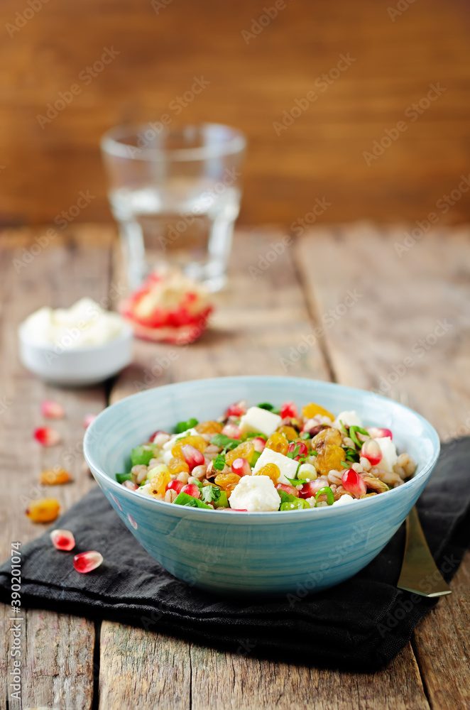 Barley pomegranate raisins feta salad in a bowl Barley pomegranate raisins feta salad in a bowl