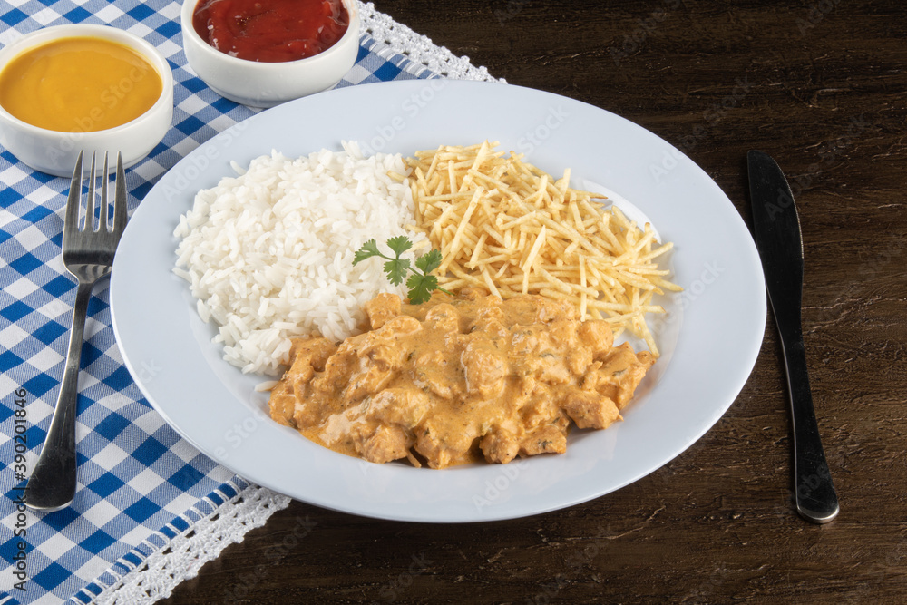 Food dish with chicken stroganoff and rice and chips. Food dish with chicken stroganoff and rice and chips.